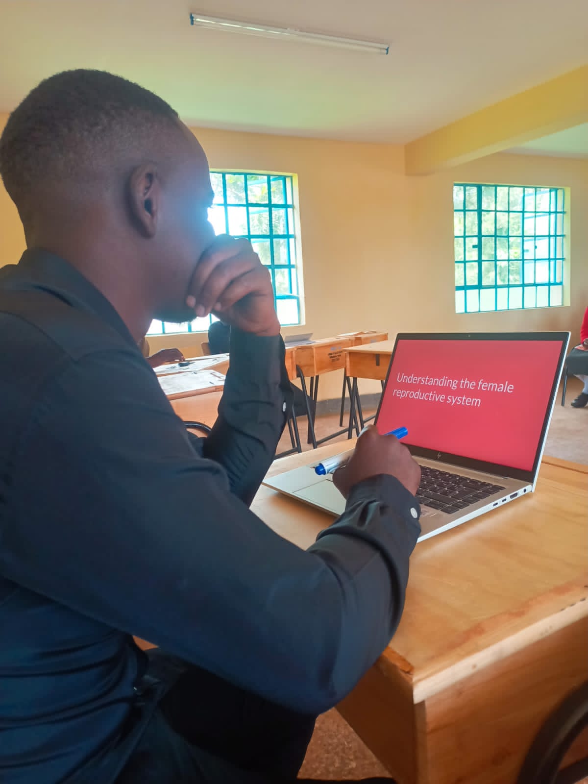 A group of students smiling and holding up items they received.